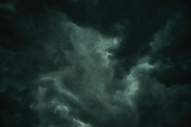 Stormy sky with heavy dark clouds in summer, low angle view