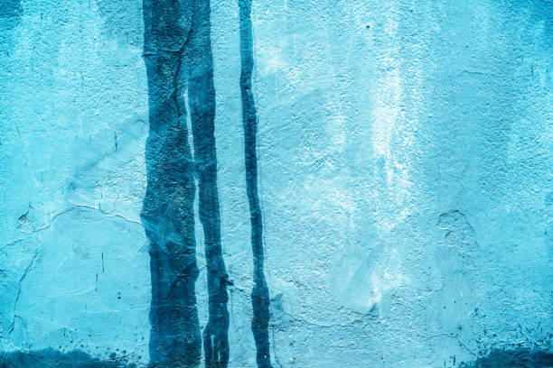Messy paint strokes and smudges on an old painted wall. Purple, color drips, flows, streaks of paint and paint sprays.