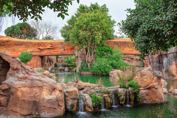 istock Picturesque waterfall surrounded by rocks 2165330611