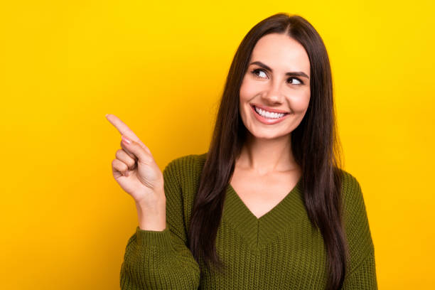 istock Photo of funky thoughtful lady wear khaki pullover looking showing finger empty space isolated yellow color background 2165330961