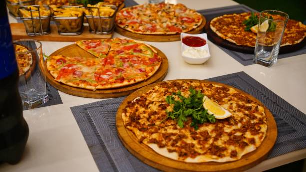 istock Assortment of Pizzas on a Tabletop 2165331442