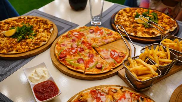 istock Restaurant Table With Pizzas and Fries 2165331495