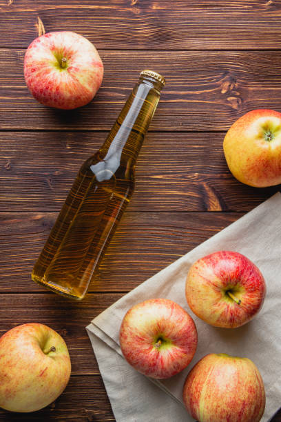 istock Apple cider in a bottle on a wooden table 2165331733