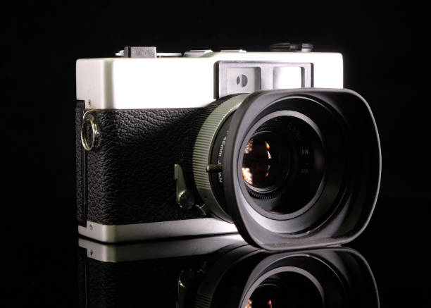 istock Retro film camera, close-up, back view, on black background. 2165332403