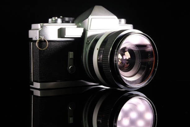 istock Retro film camera, close-up, back view, on black background. 2165332743