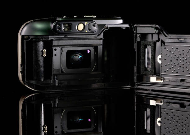istock Retro film camera, close-up, back view, on black background. 2165333372