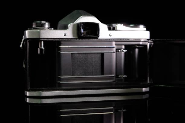 istock Retro film camera, close-up, back view, on black background. 2165333458