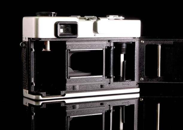 istock Retro film camera, close-up, back view, on black background. 2165333484