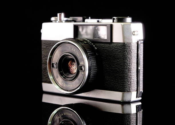 istock Retro film camera, close-up, back view, on black background. 2165333520