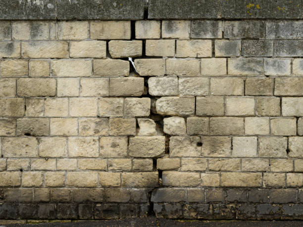A big crack in an old stone wall in the city of Arles (France)