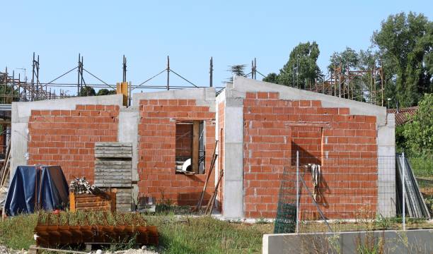 istock Single floor house under construction before plastering, with bricks exposed and concrete columns. 2165335165