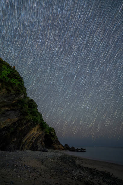 istock Stars trailing above a beach in the night sky. 2165337264