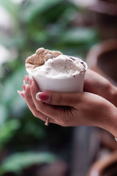 istock Hand holding a cup of ice cream 2165337713