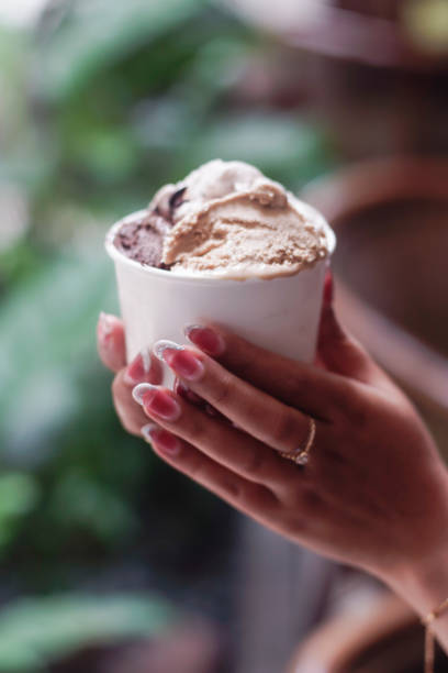 istock Hand holding a cup of ice cream 2165337755