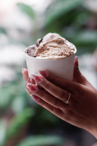 istock Hand holding a cup of ice cream 2165337779