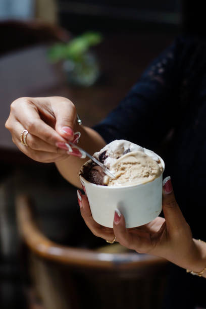 istock Hand holding a cup of ice cream 2165338064