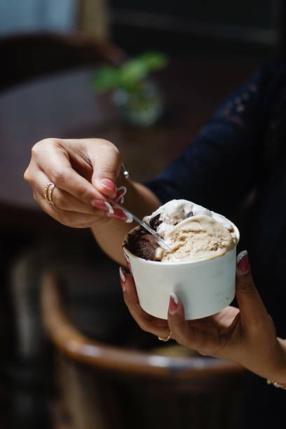 istock Hand holding a cup of ice cream 2165338087