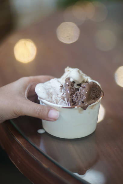 istock Hand holding a cup of ice cream 2165338314