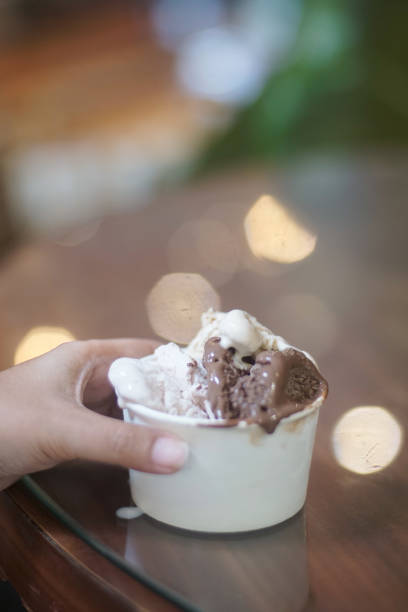 istock Hand holding a cup of ice cream 2165338321