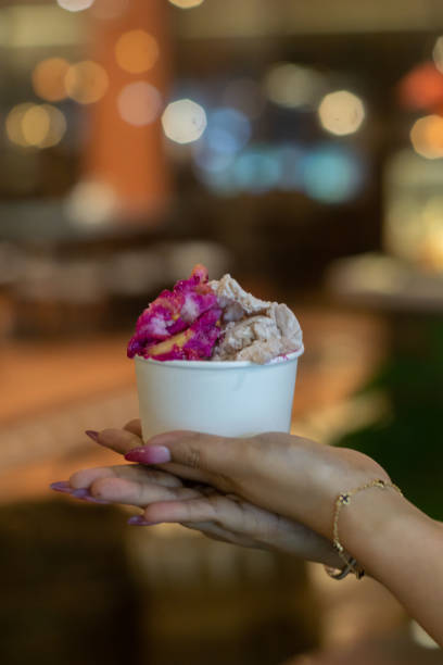 istock Hand holding a cup of ice cream 2165338384