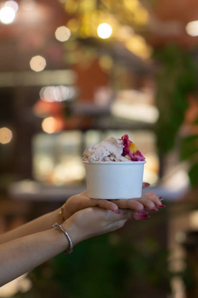istock Hand holding a cup of ice cream 2165338418