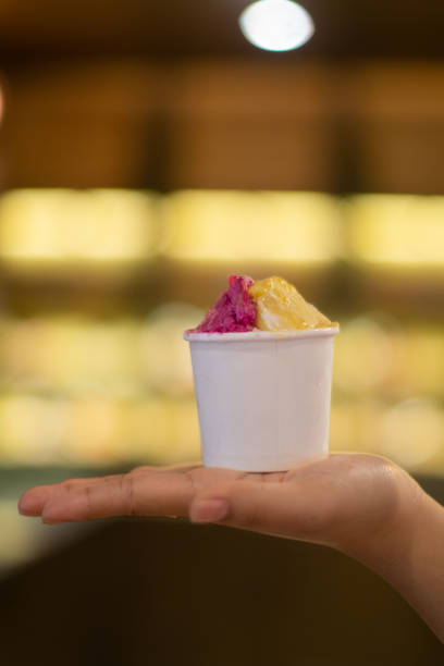 istock Hand holding a cup of ice cream 2165338446