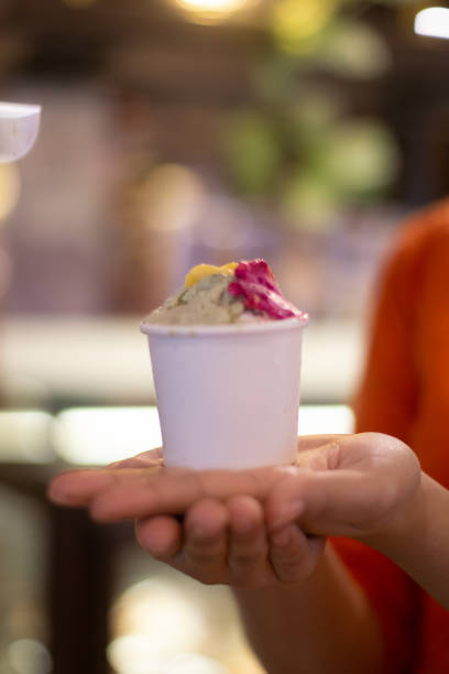 istock Hand holding a cup of ice cream 2165338477