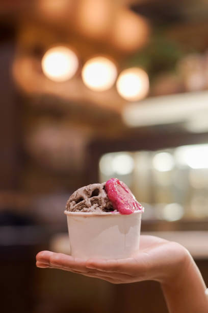 istock Hand holding a cup of ice cream 2165338513