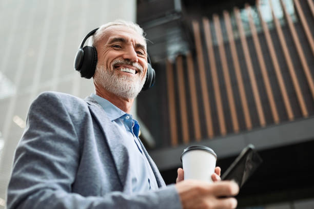 istock Businessman Using Phone with Headphones 2165338541