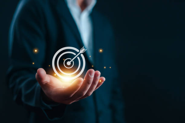 Businessman holding target icon