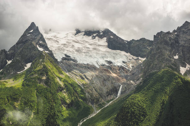 istock mountains with green grass and stormy sky 2165346996