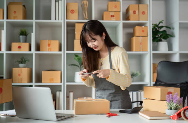 istock Young Woman Entrepreneur Checking Produc Order Online in a Modern Home Office Setting 2165346997