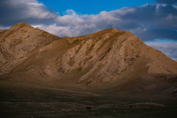 istock Dusk at Sayram Lake: Rugged Mountains, Blue Sky, and Shifting Clouds 2165347057