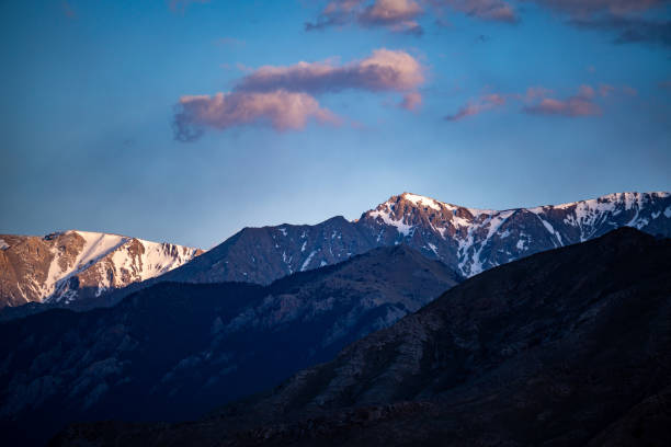 istock Dusk at Sayram Lake: Snow-capped Peaks with Blue Sky and Clouds 2165347246