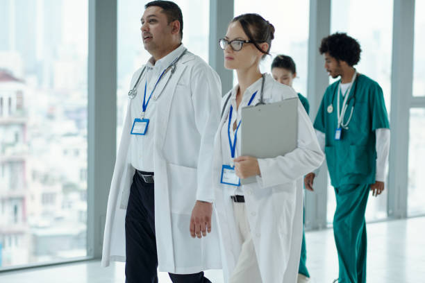 istock Doctors Walking Along The Hospital Corridor 2165350527