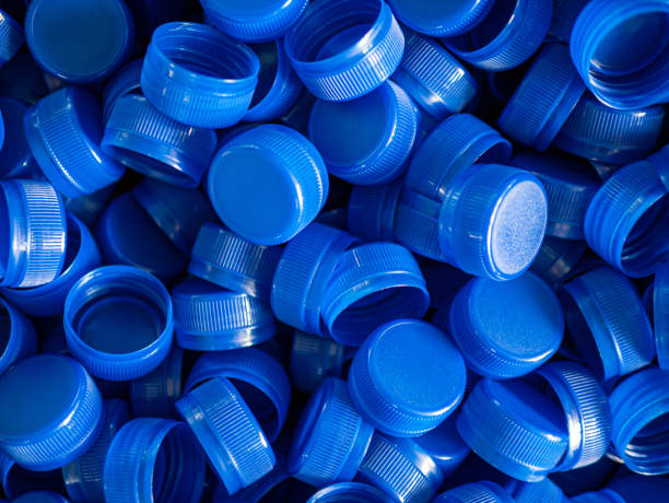 istock Top view blue plastic bottle caps.Recycling collection and production processing plastic bottle caps background ,Industrial production of bottle caps made of blue high-density polyethylene. 2165351869