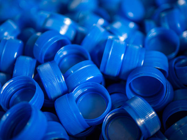 istock Close-up of blue plastic bottle caps.Recycling collection and production processing plastic bottle caps background ,Industrial production of bottle caps made of blue high-density polyethylene. 2165351895