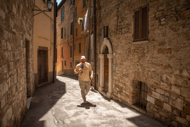 Handsome senior mature male tourist enjoying a sightseeing day in Perugia, Umbria