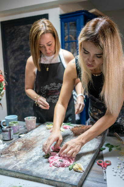 istock two women relief artist are working on canvas at studio vertical working with hands still 2165355131