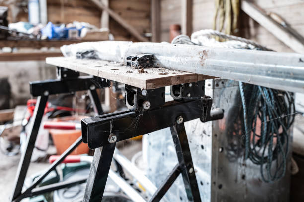 istock Grimy adjustable workbench seen in the confines of a farm workshop. 2165355136