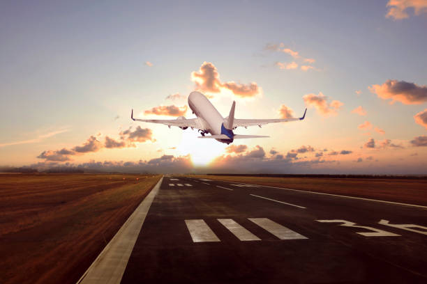 istock Passenger airplane is taking of at sunset 2165356143