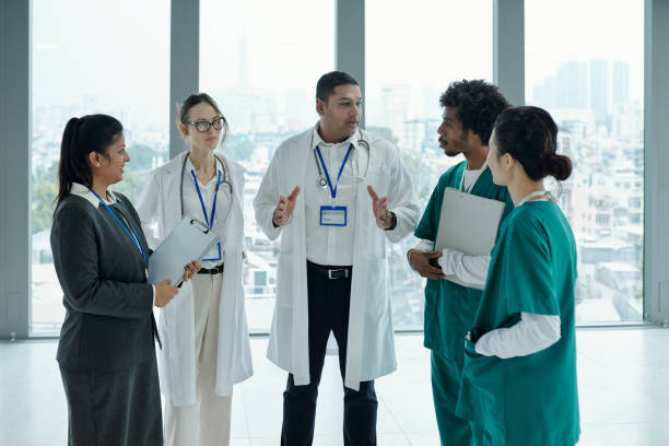 istock Team Of Doctors Discussing Diagnosis 2165356173