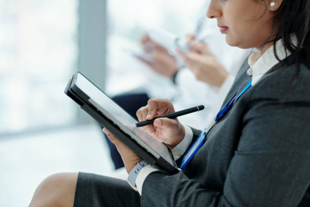 istock Businesswoman Using Tablet PC At Conference 2165357409