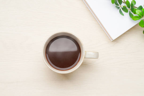 istock Hot cocoa isolated on wooden table 2165357513