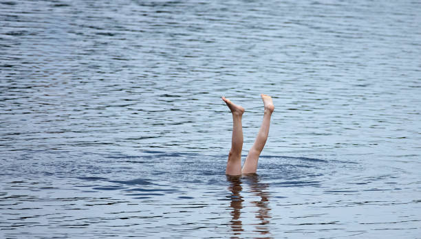 istock Feet First Dive in a Rippling Lake 2165357749