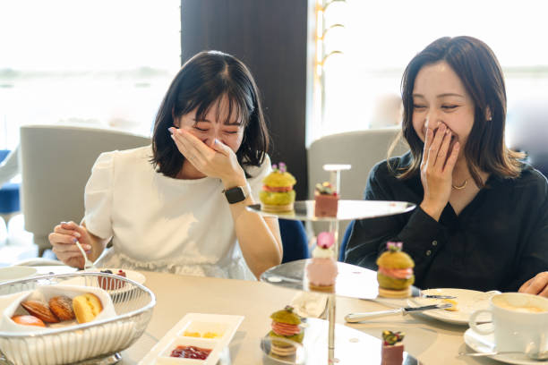 istock Young women enjoying afternoon tea at cafe 2165358225