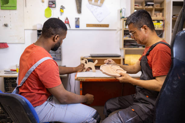 istock Carpenters smoothing wooden crafts 2165359011