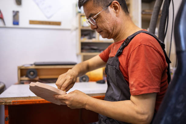istock Carpenter smoothing wooden craft 2165359146