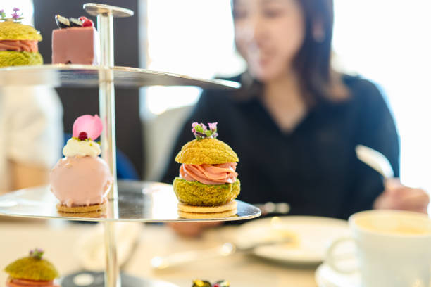 istock Young women enjoying afternoon tea at cafe 2165359196