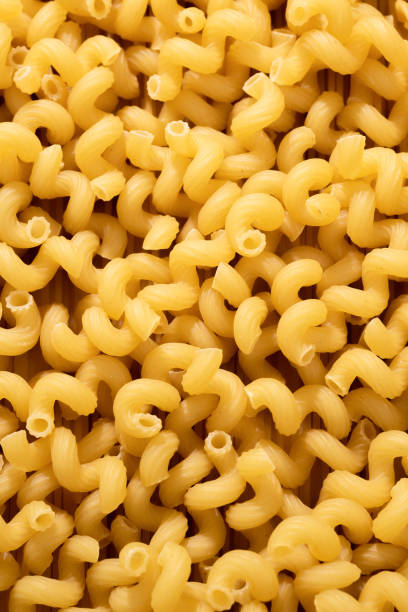 istock Macaroni pasta closeup background or wallpaper. Pasta raw closeup background 2165359437